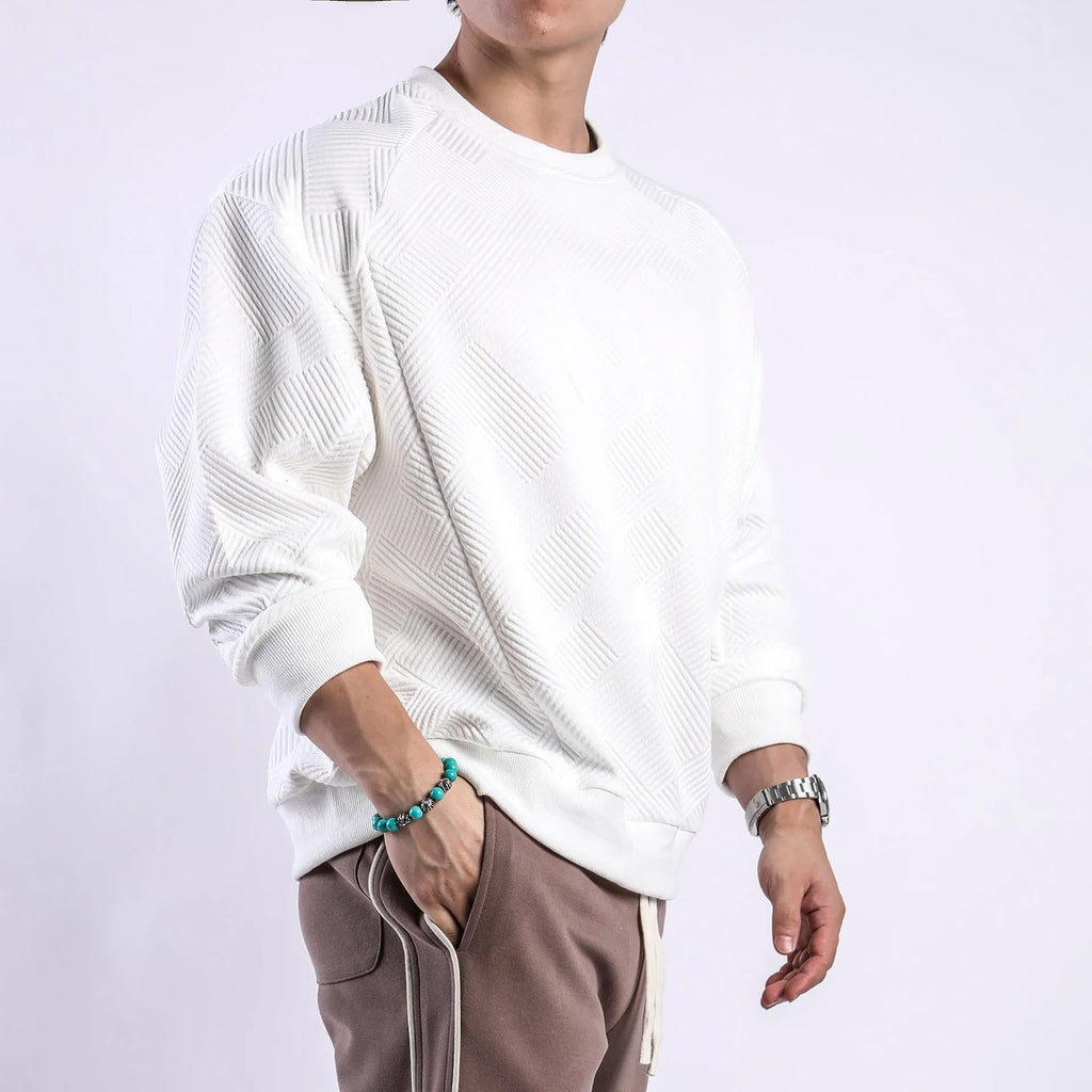 Men's loose fit solid colour twill jacquard pullover sweater on a hanger.