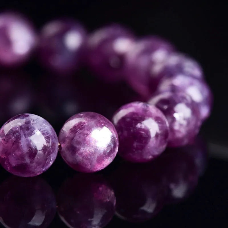 Grandmother crystal bracelet with polished geometric beads in purple on a wrist.