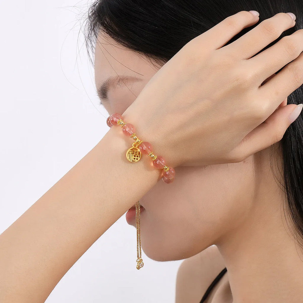 Women's strawberry quartz crystal bracelet with geometric shape and silver fu character design