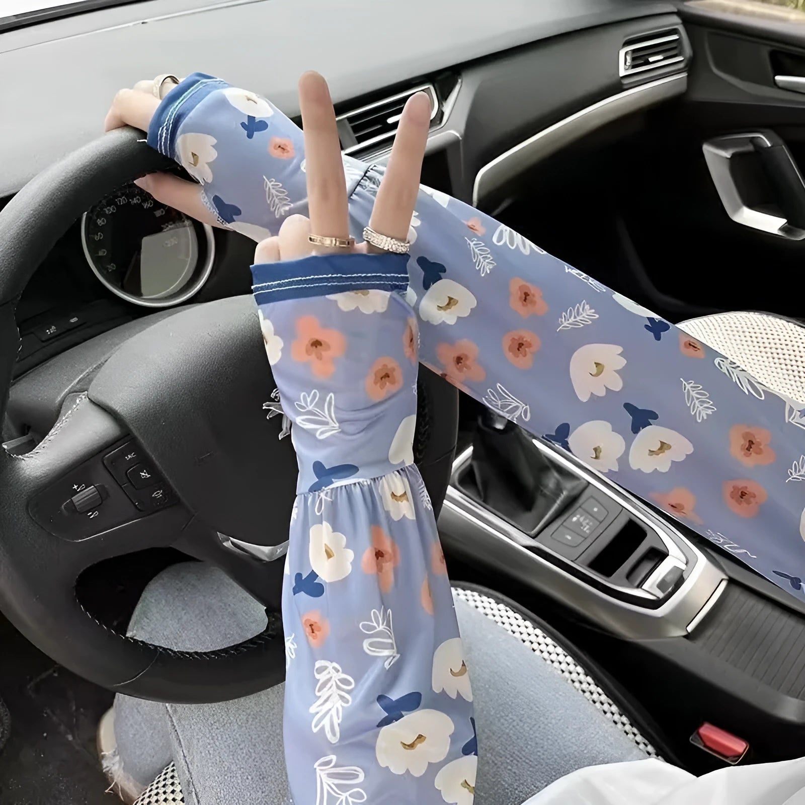 A pair of lightweight ice silk sun protection sleeve gloves in a floral print pattern, covering from wrist to elbow.