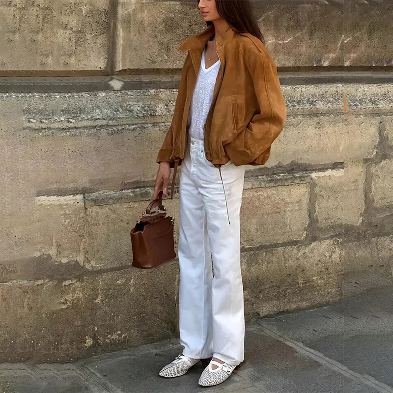 Man wearing a solid colour loose-fit retro polyester jacket with long sleeves.