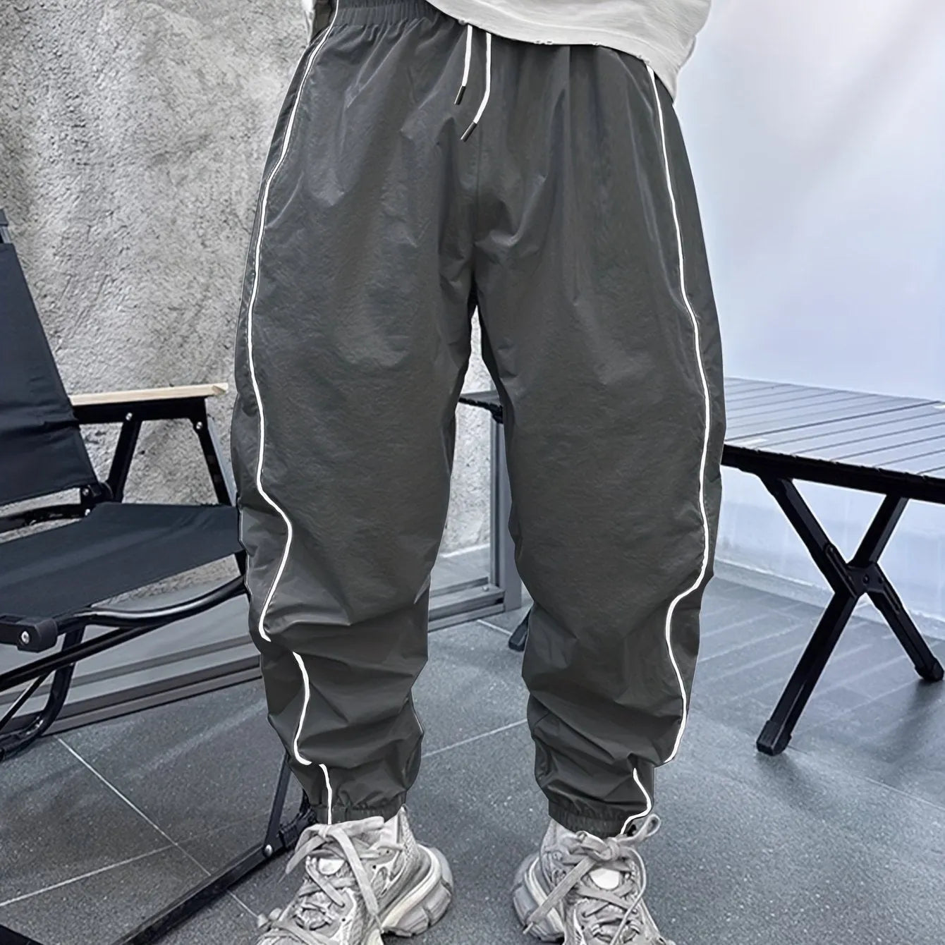 Men's blue bamboo fibre casual sports trousers with cropped length and loose fit on a hanger.
