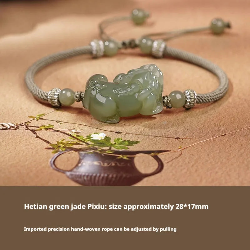 Close-up of a brown and black braided rope bracelet with a central Hetian jade bead on a wrist.
