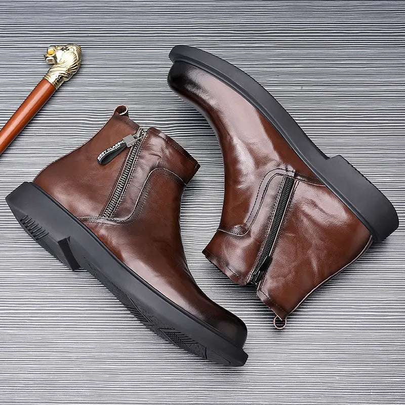 Men's brown and black genuine leather Chelsea boots with side zipper, mesh lining, low heel, and rubber sole.