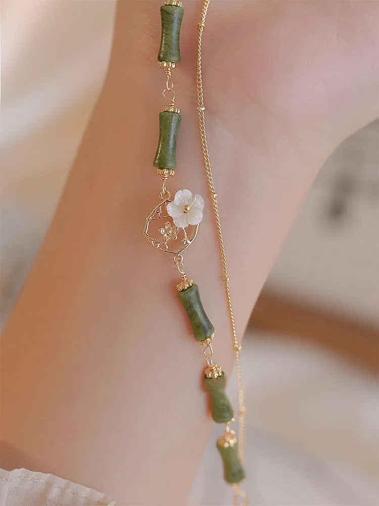 Handmade olivine bracelet with double layer Twin Bells of Ireland design on adjustable string cord