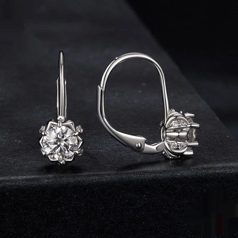 Sterling silver flower bud ear clips with white gold plating and a moissanite centre stone.