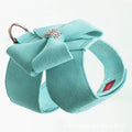 A pink microfiber dog chest strap with a white bowknot, showing the adjustable size buckles.