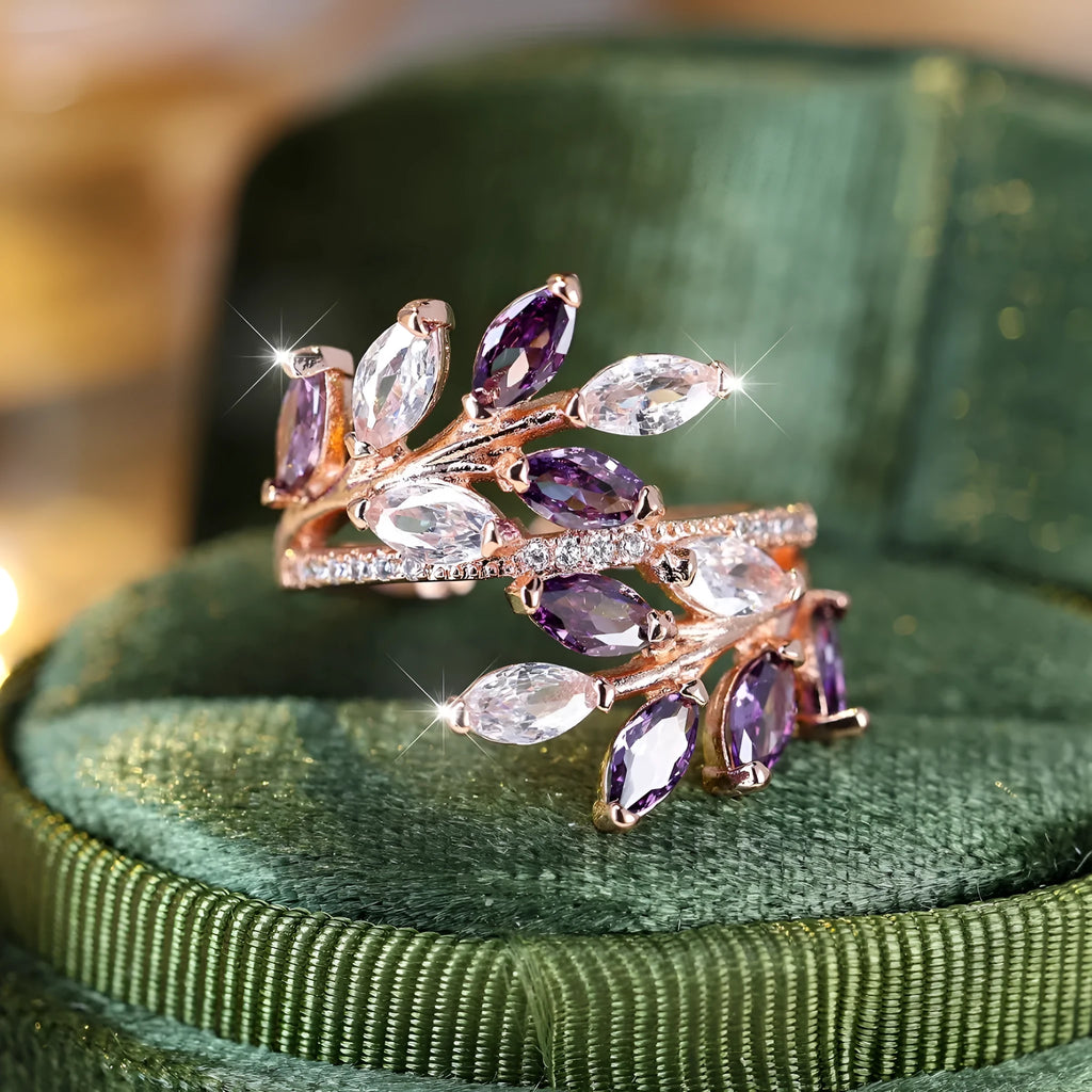 Adjustable copper leaf ring with a central zircon stone on a finger, showing rose gold and platinum colour options.