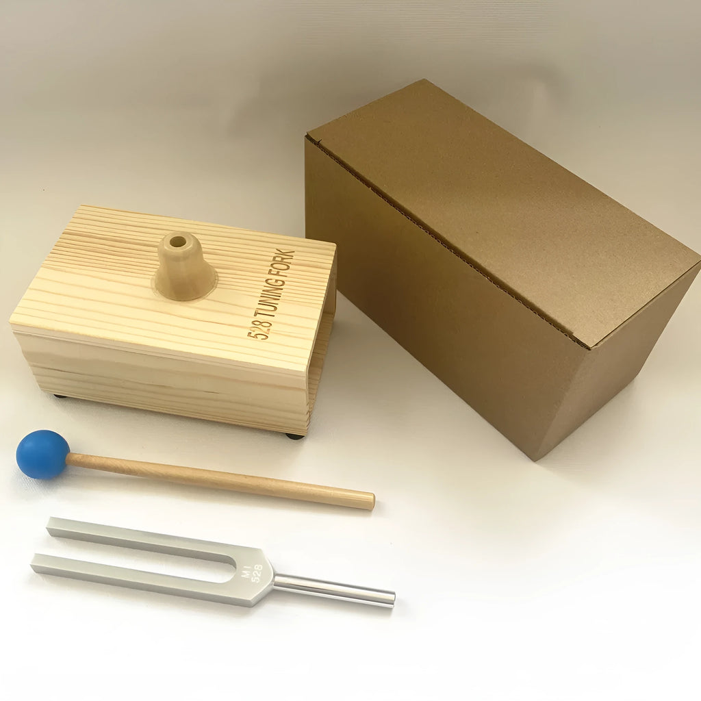 Aluminium alloy 432Hz tuning fork and portable speaker kit on a kraft paper box.