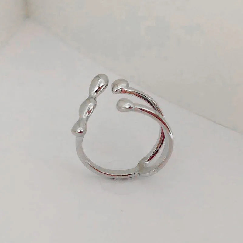 Brass spherical ring for women in gold or silver colour on a circular band.