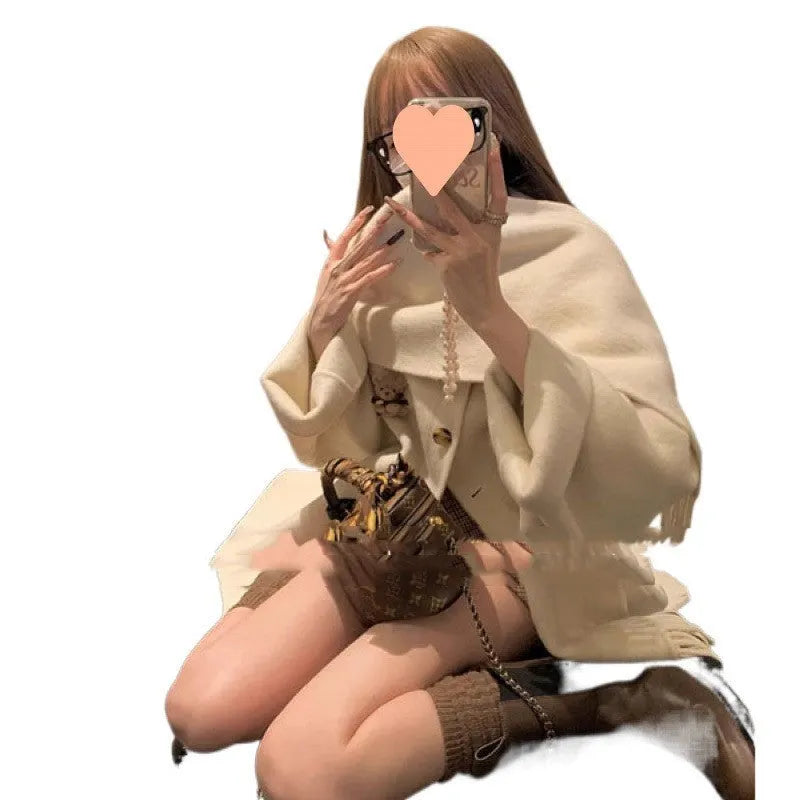 Gold Cloak loose-fitting tassel woolen coat in cream white on a female model