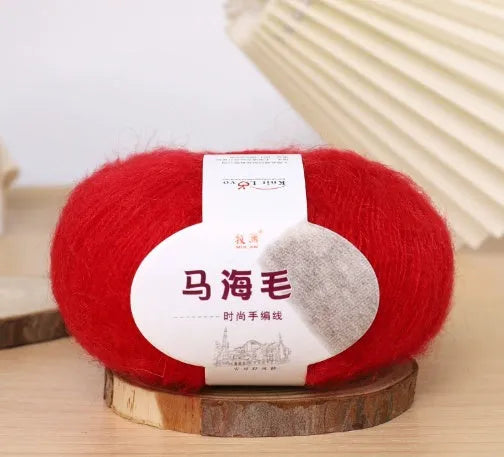 Ball of mohair yarn for DIY scarf knitting in one of 34 colours, including white, pink, blue, and green.