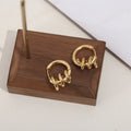 Spiral wound ear clip frosty style geometric earrings in gold colour on white background