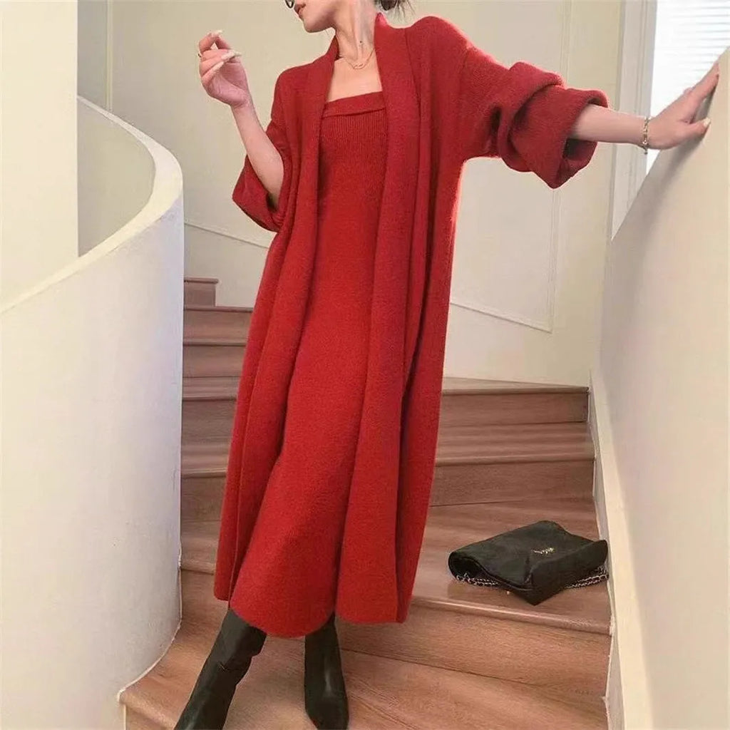Woman wearing a grey knitted cardigan over a matching long dress with a flocked texture detail.