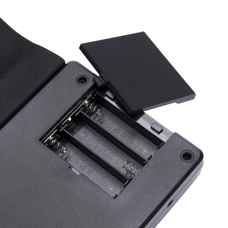 Pearlescent white roll-up silicone electronic keyboard next to its compact 28cm carrying case