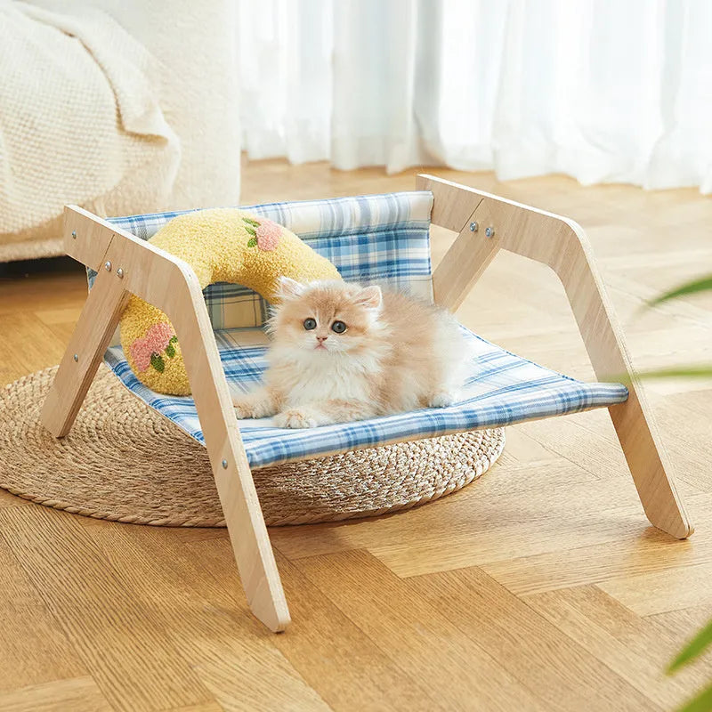 Wooden cat beach chair bed with blue cloth hammock suspended from frame