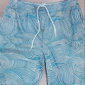 Men's straight-leg shorts with 3D digital printing on blue micro-elastic polyester fabric, laid flat.