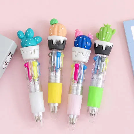 A press-action ballpoint pen with a four-colour cartridge, showing one of five random cartoon designs on the barrel.