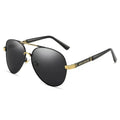 Gold metal frame polarised sunglasses with grey lenses on a table, showing dragon and phoenix temple detail.