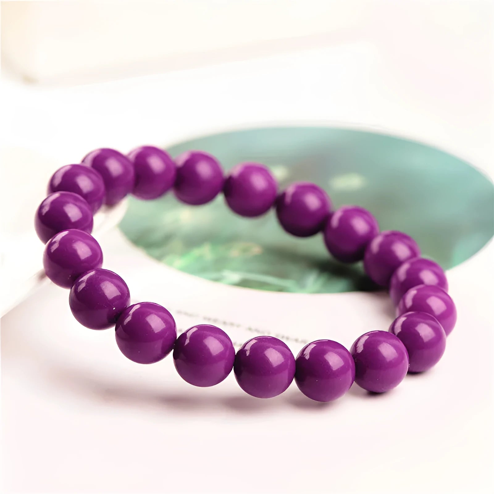 Jiuya purple mica crystal bracelet showing polished beads in a single circle design on a wrist.