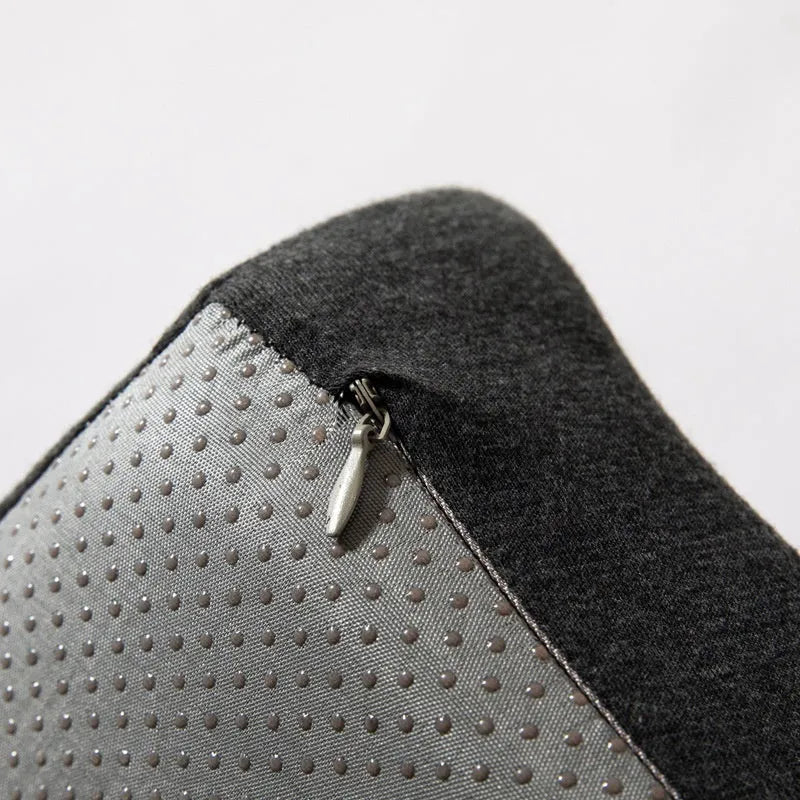 Dark grey memory foam office chair cushion for lumbar support on a desk chair.
