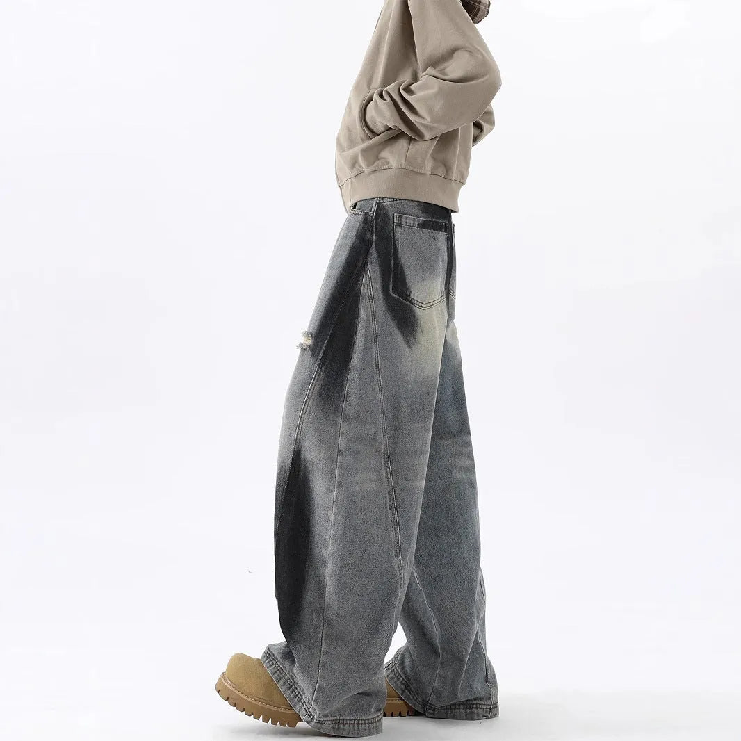 Men's blue ripped jeans with splash-ink design detail showing cotton fabric with micro elasticity