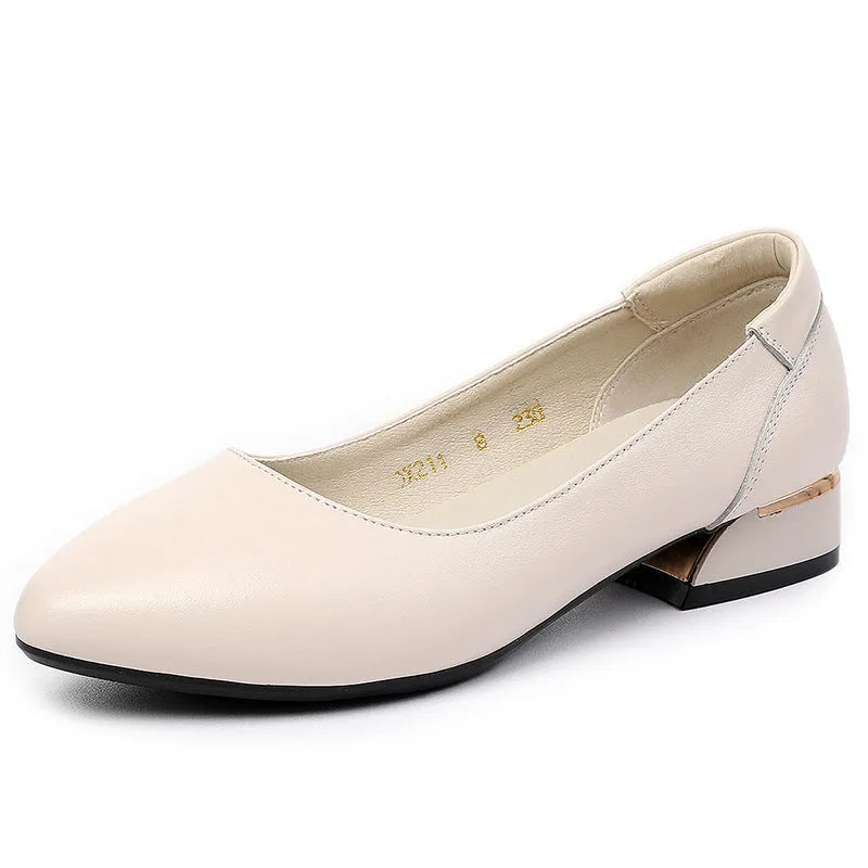 Beige low top casual shoes with pointed toe, buckle fastening, and a thick flat heel.