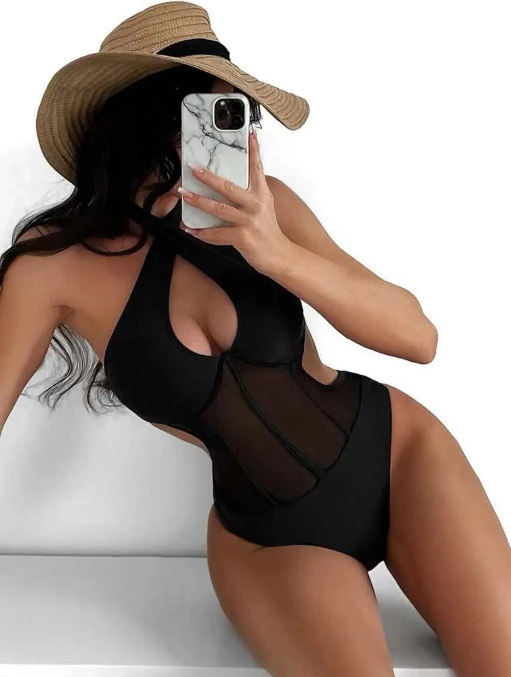 Women's black one-piece swimsuit bikini made of nylon and spandex fabric on a neutral background.