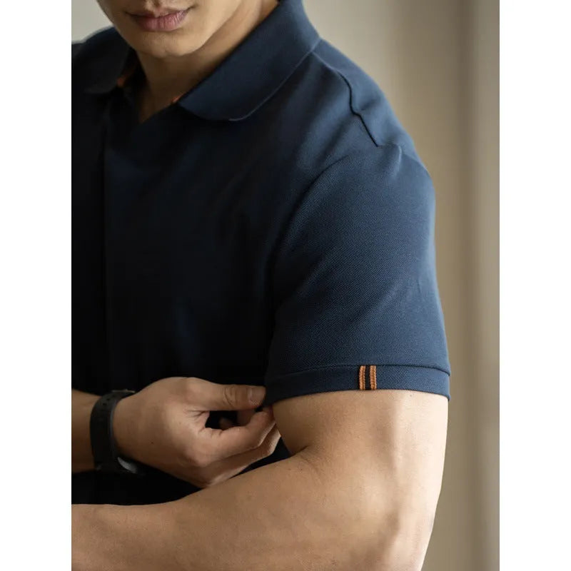 Blue short-sleeved polo shirt on a hanger, showing regular fit and cotton-polyester fabric blend.