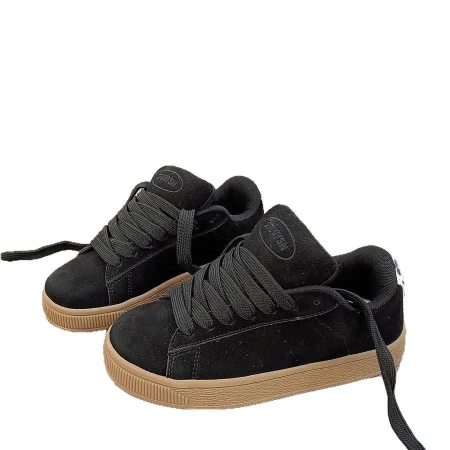 Retro black low-top sneakers on a waterproof platform sole with round toe and lace-up front.