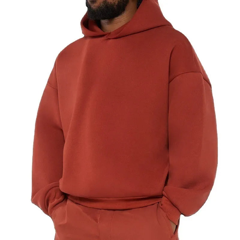 A man's solid-colour fleece-lined cotton hoodie with a wool interior, shown in a casual setting.