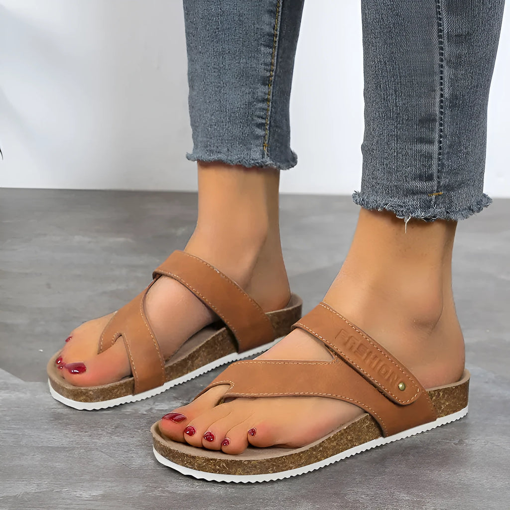 Blue thick-soled flat toe ring flip-flops on a white background.