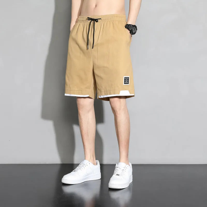 Boys' cotton shorts in black, khaki, or white, showing mid-waist and shorts length design.