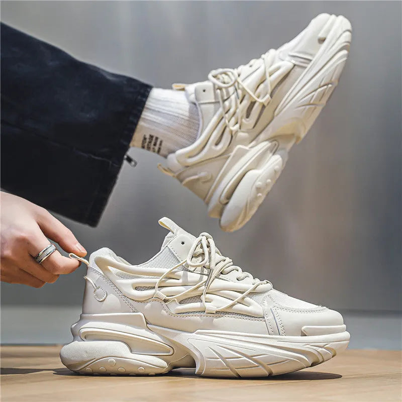 Men's low-top sneakers in beige with mesh upper, rubber sole, and front lace-up design on a white background.