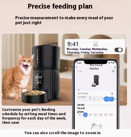 Black automatic pet feeder with digital timer display and remote control on a table.