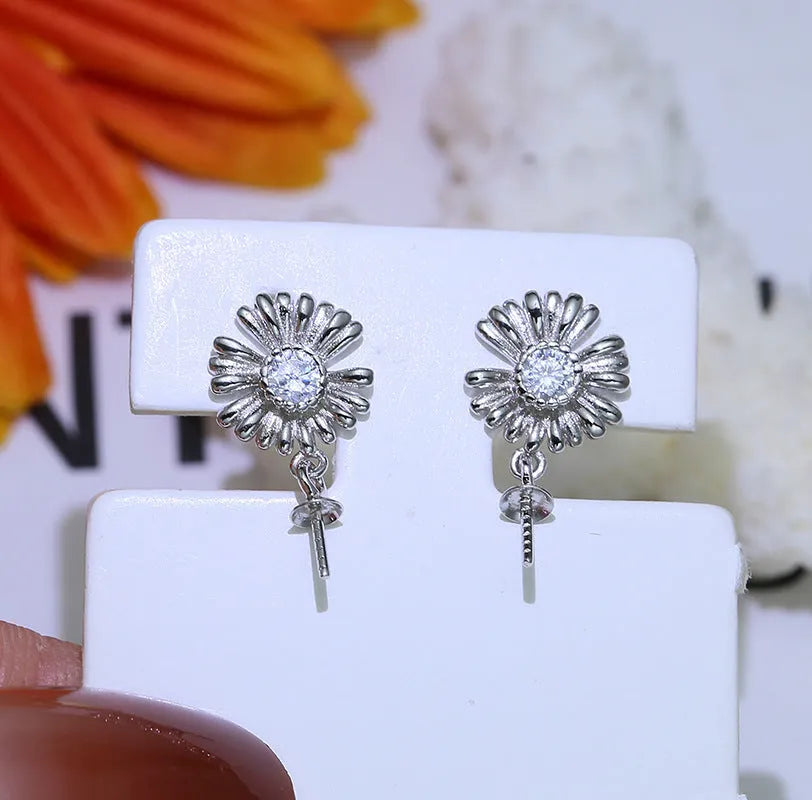 Adjustable Baroque style sterling silver flower drop earrings on a ring holder ear wire.