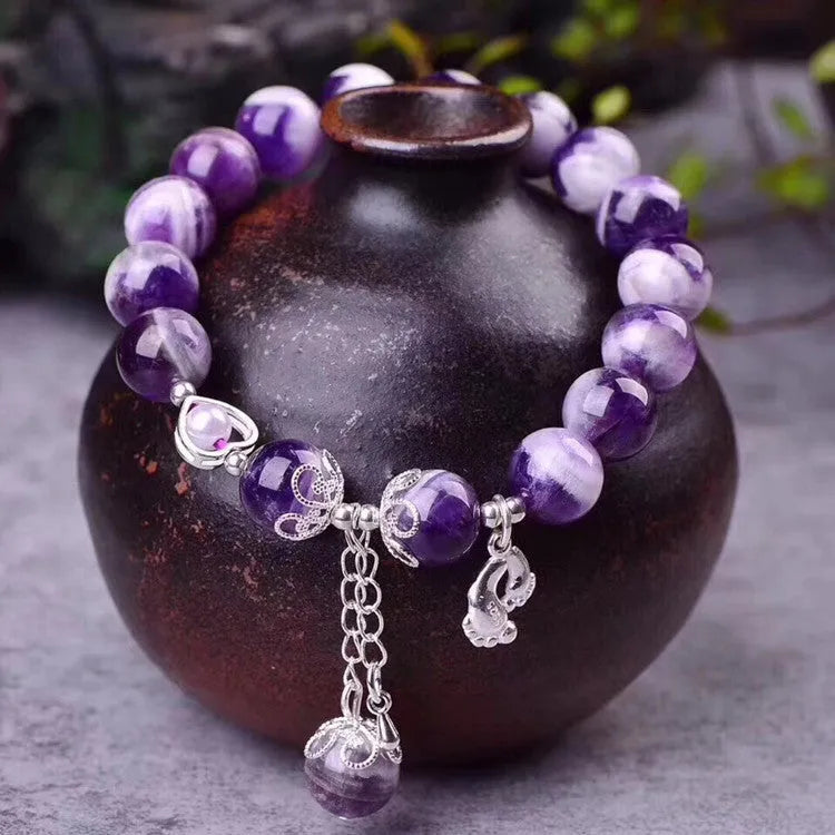 Purple amethyst gemstone bracelet with 10mm round beads on woman's wrist