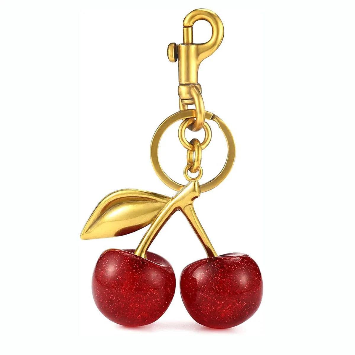 Close-up of a red zinc alloy keychain pendant with a three-dimensional cherry design.