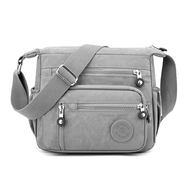 Soft nylon messenger bag in square vertical shape with single shoulder strap