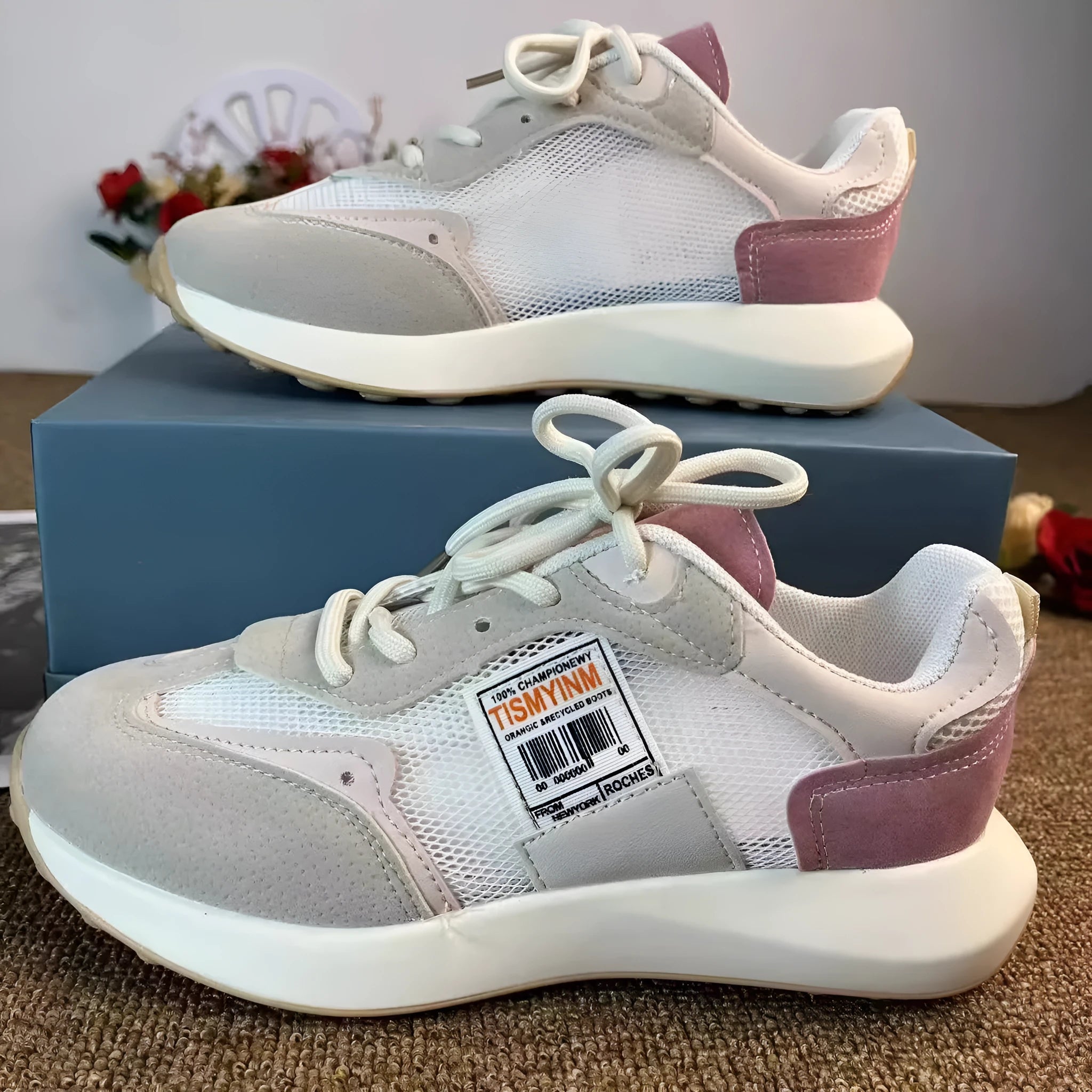 Women's grey and pink retro sneaker with low top design and round toe