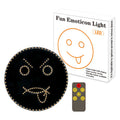 Black car rear window LED expression light showing smiley face design with orange illumination