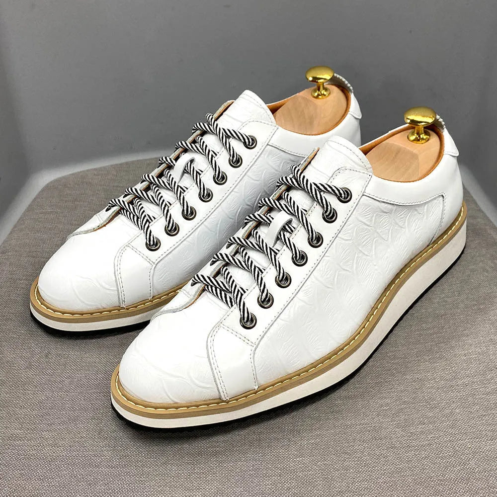 Men's low-top white shoes with embossed pattern texture on the front, featuring front-tie laces.