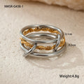 Stacked gold plated stainless steel rings with an exaggerated design on a person's hand.