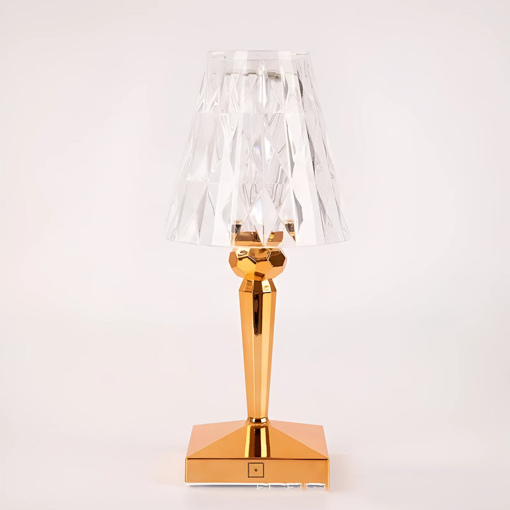 Rose gold portable touch projection night light on a surface, showing its acrylic body and dimming controls.
