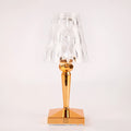 Rose gold portable touch projection night light on a surface, showing its acrylic body and dimming controls.