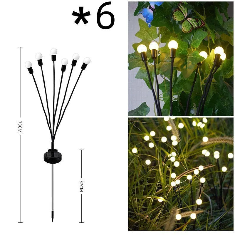 Solar-powered LED firefly garden spike light with multiple heads and a press-in ground plug on grass.