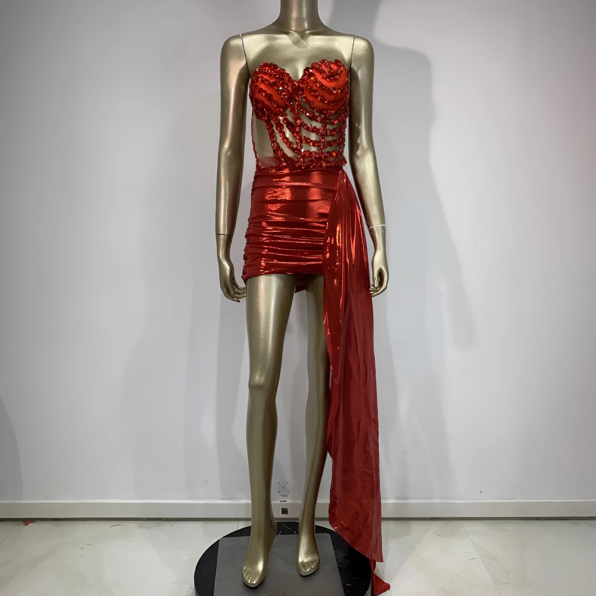 Red women's spandex skirt suit with see-through hollow mesh panels for stage performance.