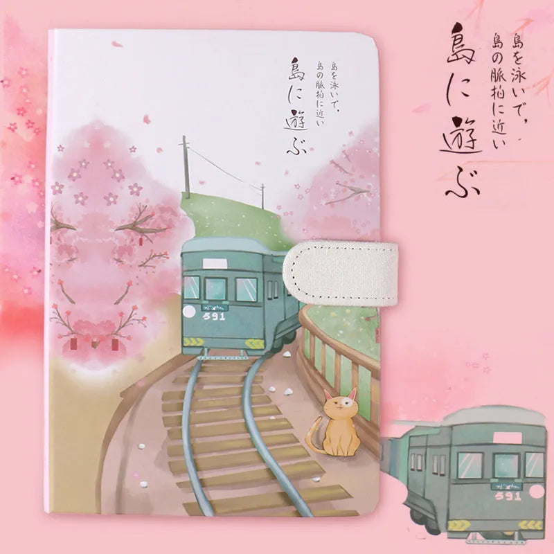 Retro style A5 wire-bound notebook open showing full-colour illustration pages, with a pen