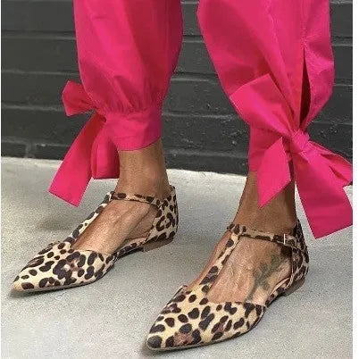 Leopard print women's pointed toe pumps with a low chunky heel and an ankle cross-strap.