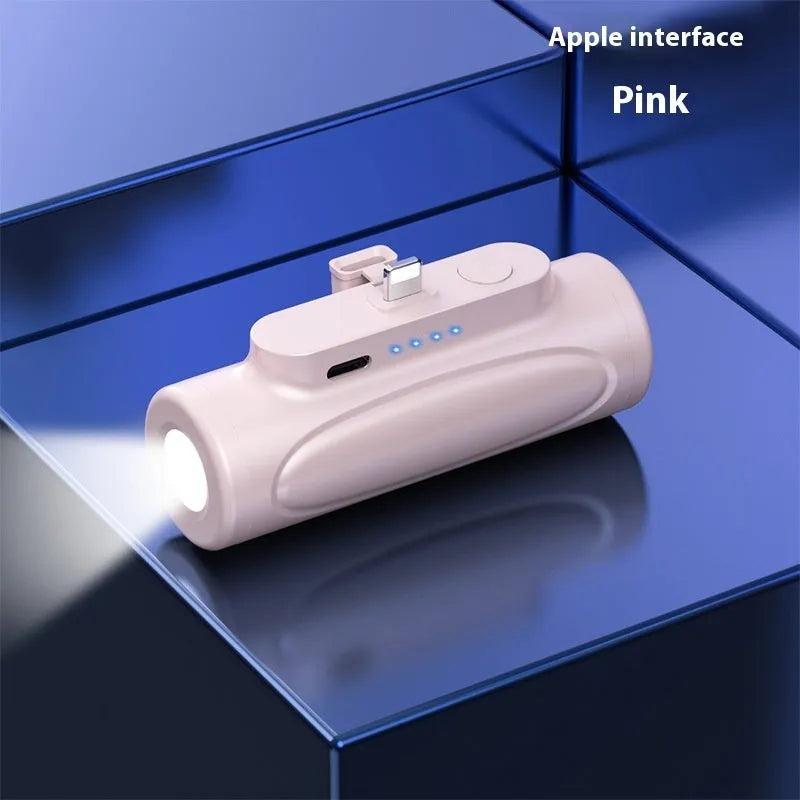 Black and pink Creative Power Bank with integrated LED flashlight, showing Apple and Type-C port options.